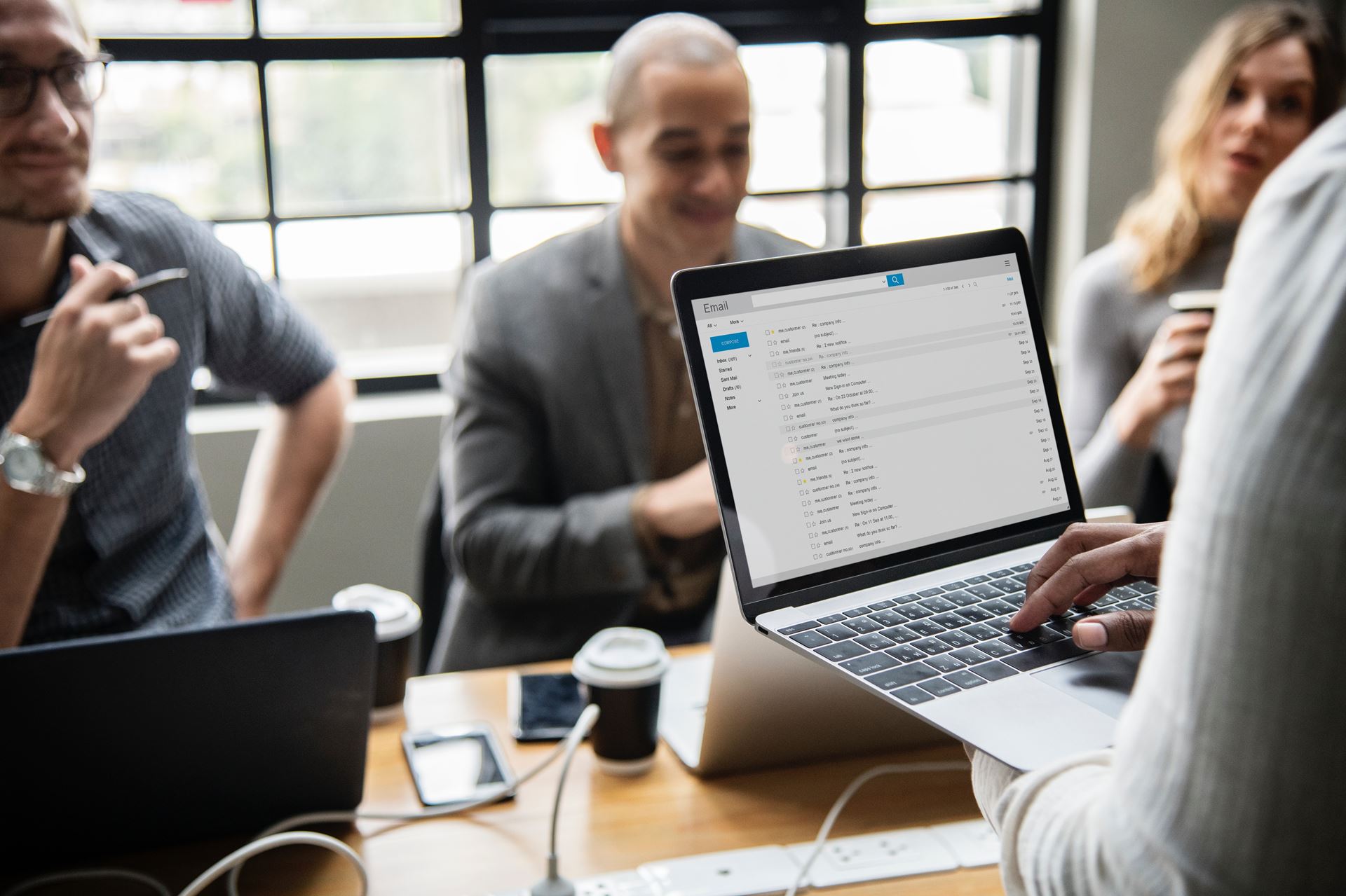 a group of people looking at a laptop